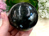 Nuummite 63mm Sphere WI - Third Eye Chakra Stone